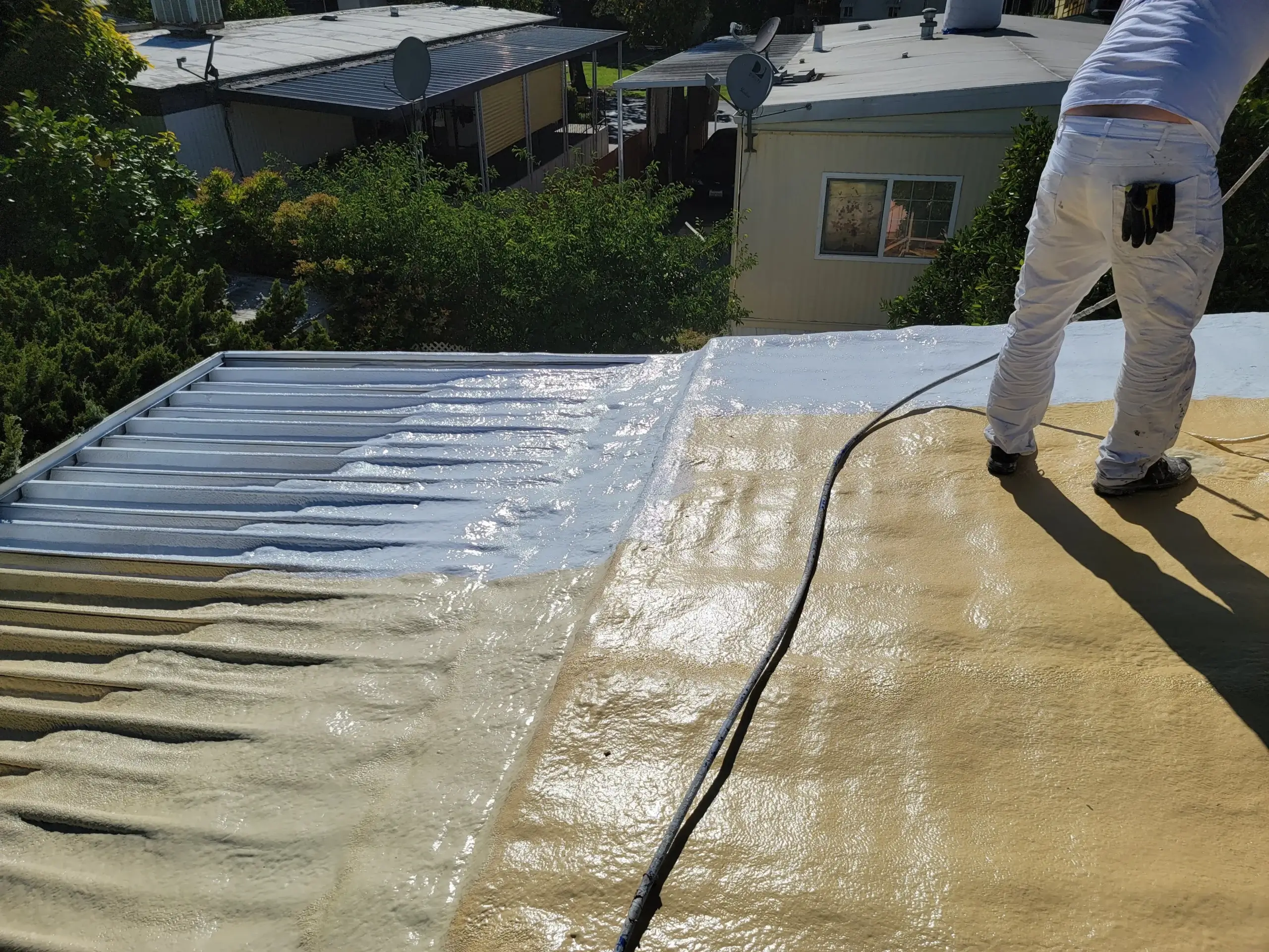 Spray polyurethane foam roofing system being applied on a Bay Area commercial flat roof