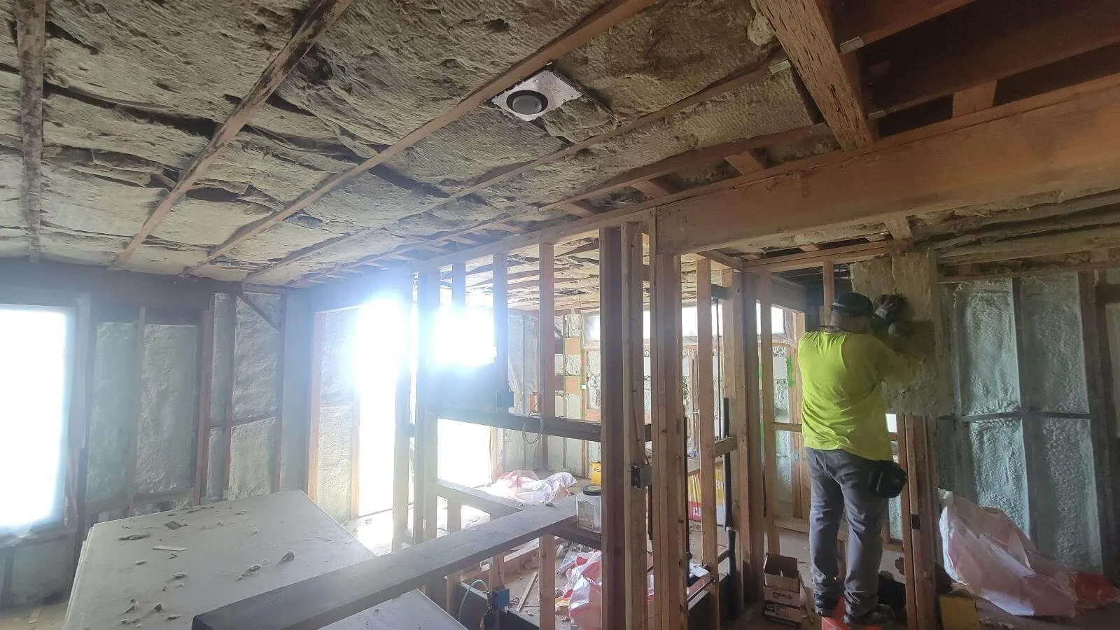 Acoustic insulation between floor joists of a multi-unit building