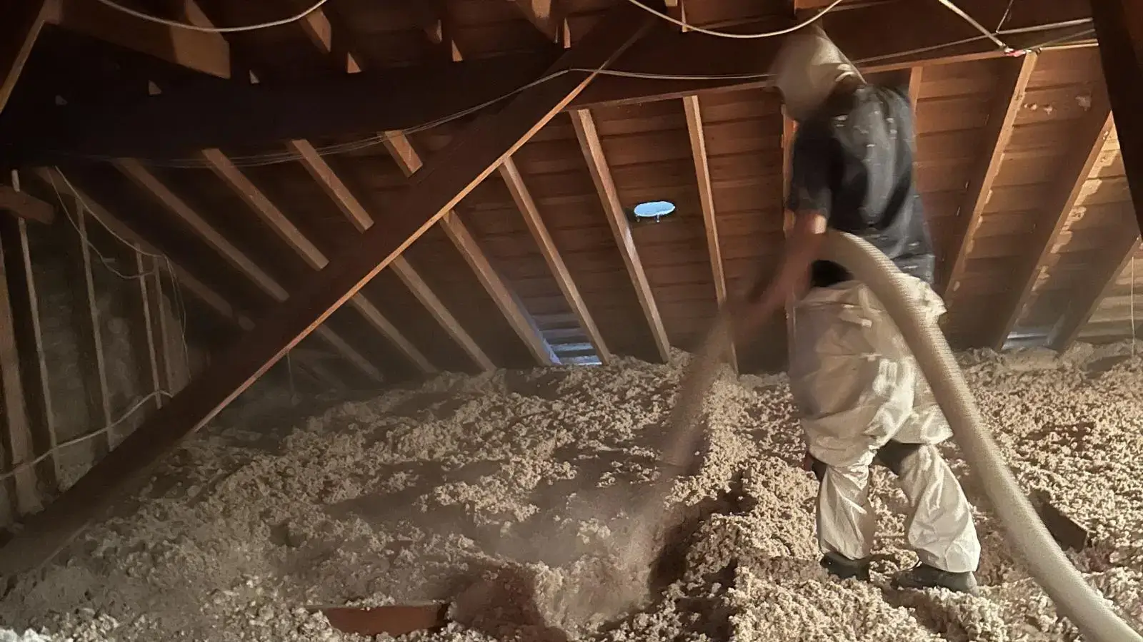 Blown-in cellulose insulation being installed in a Bay Area attic