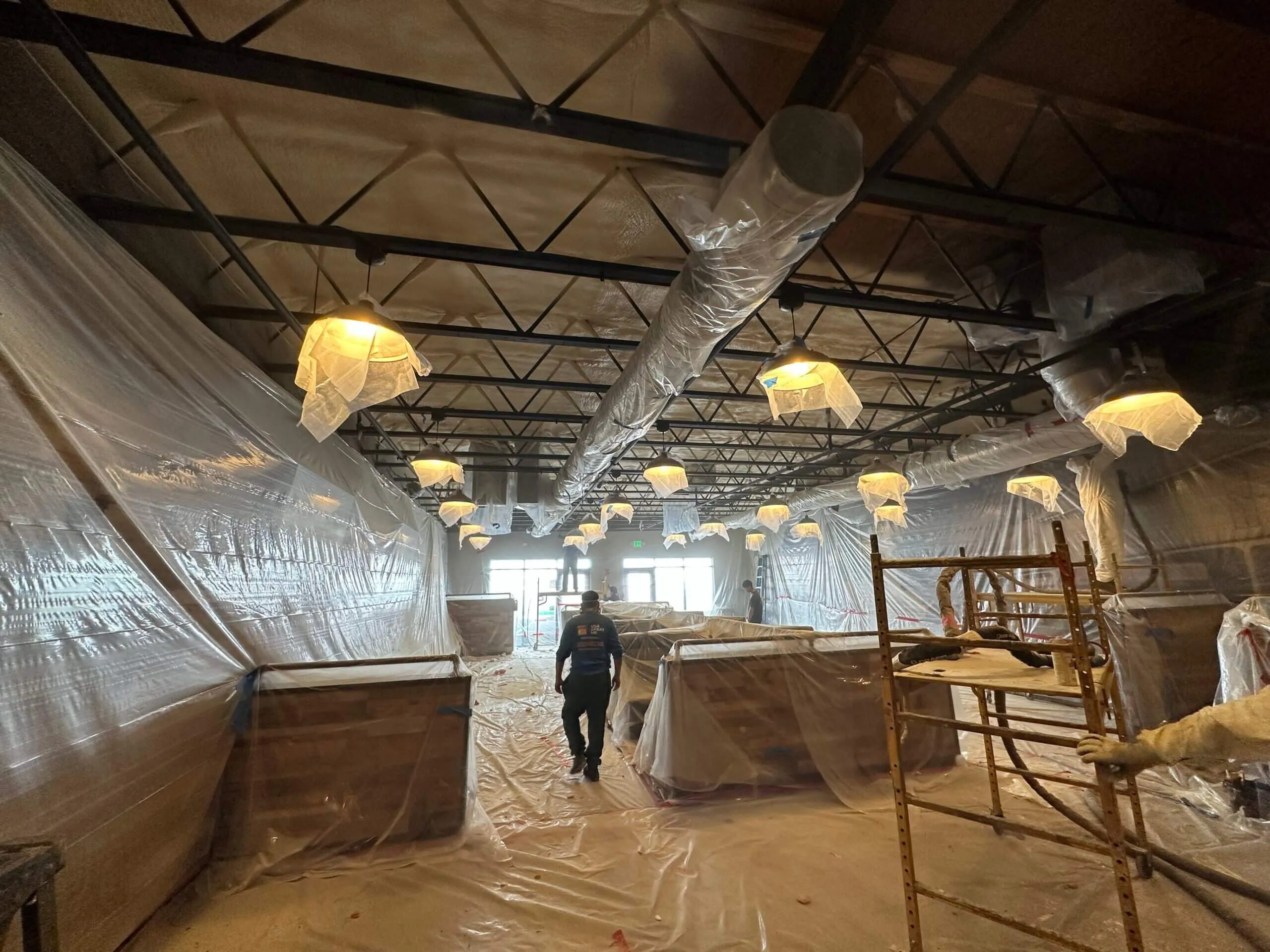 Commercial warehouse ceiling insulated with spray polyurethane foam