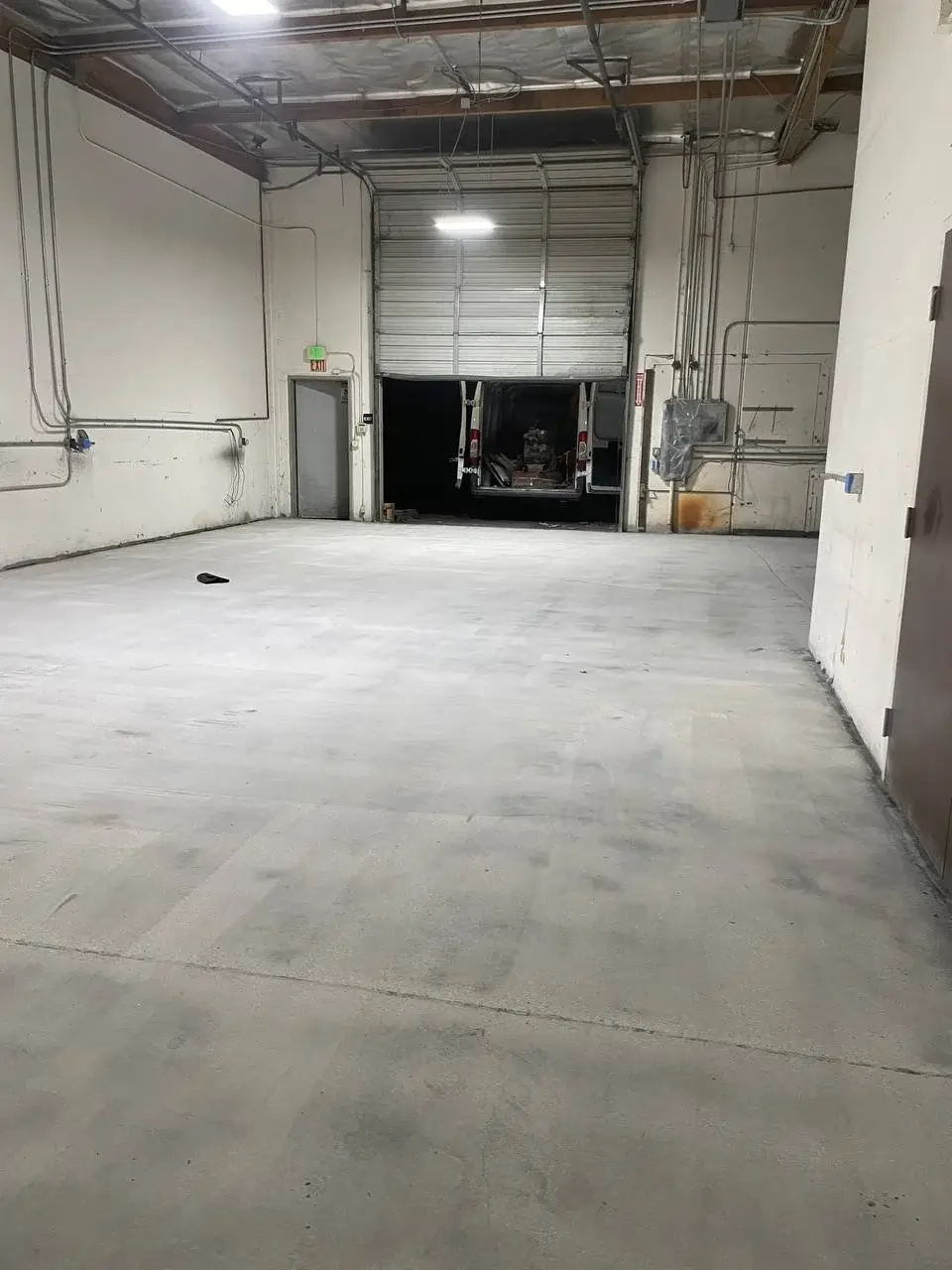 Polished concrete showroom floor reflecting lights