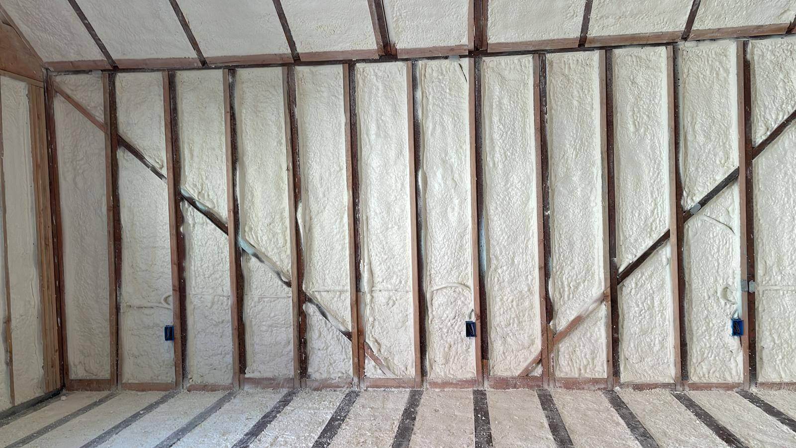 USA Spray Me crew spraying polyurethane foam in a commercial building