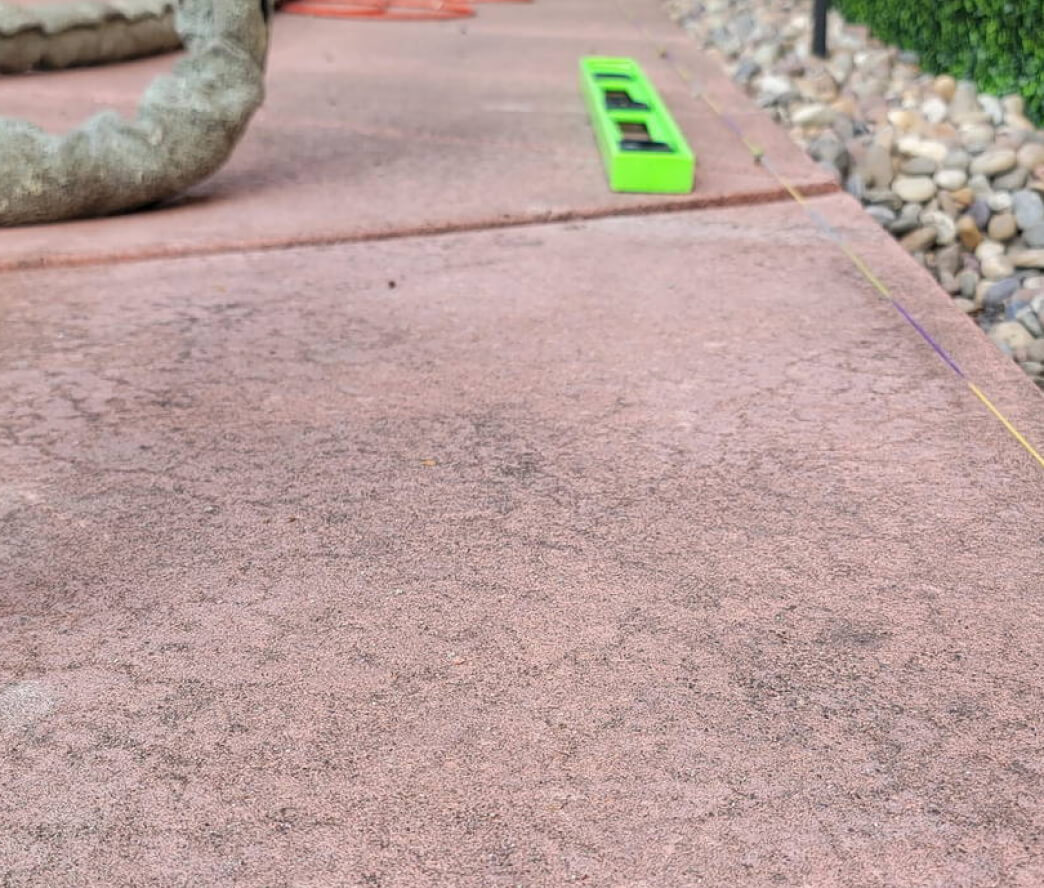 Leveled concrete driveway after foam lifting