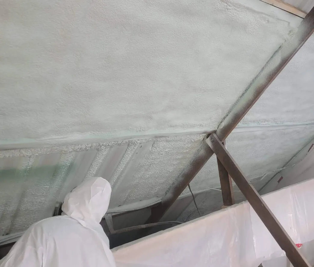 Closed-cell spray foam applied to a metal building wall