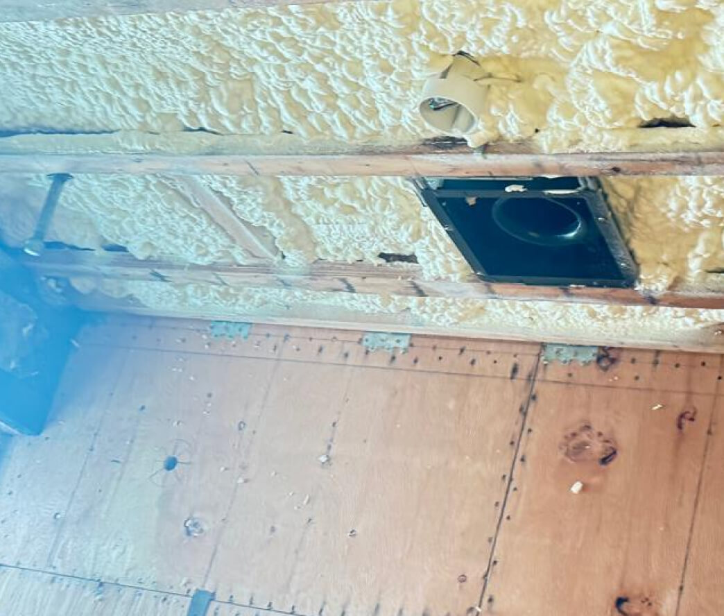 Rigid closed-cell foam insulation in a basement ceiling