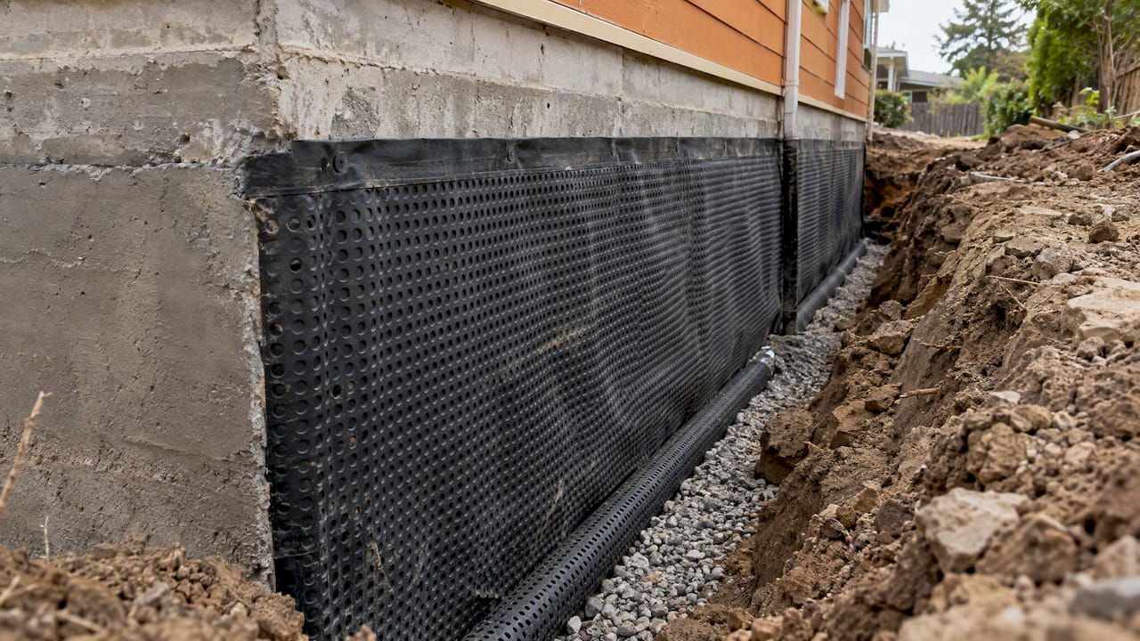 Membrane and drainage beside an exposed foundation